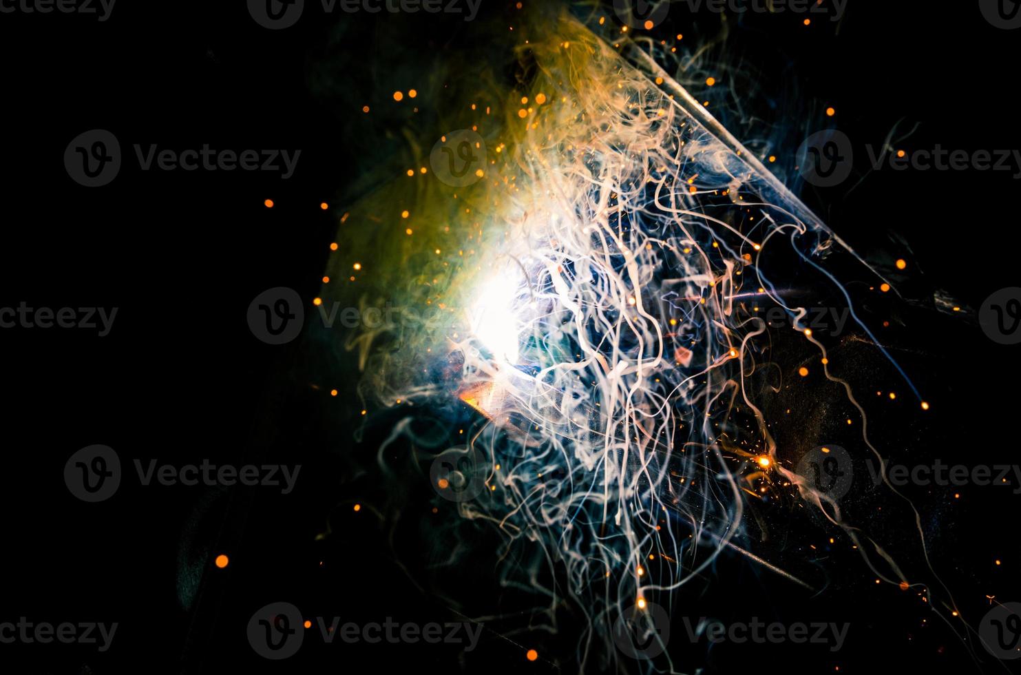 Tig welding dual core plasma flux blasts of energy, light, smoke, sparks, and flame photo