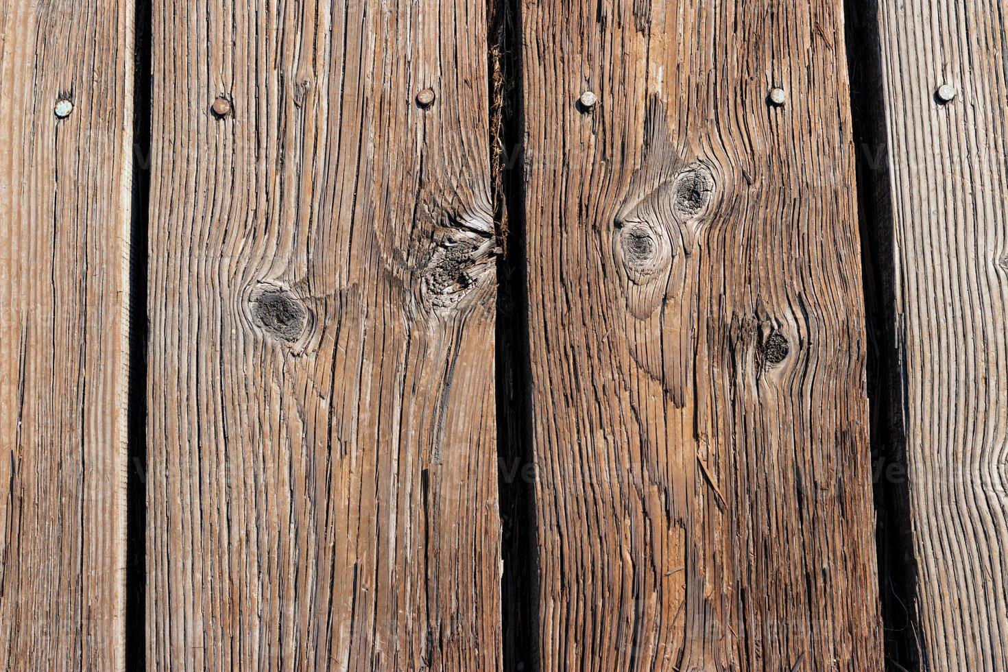 Aged wooden planks nailed to a boardwalk photo