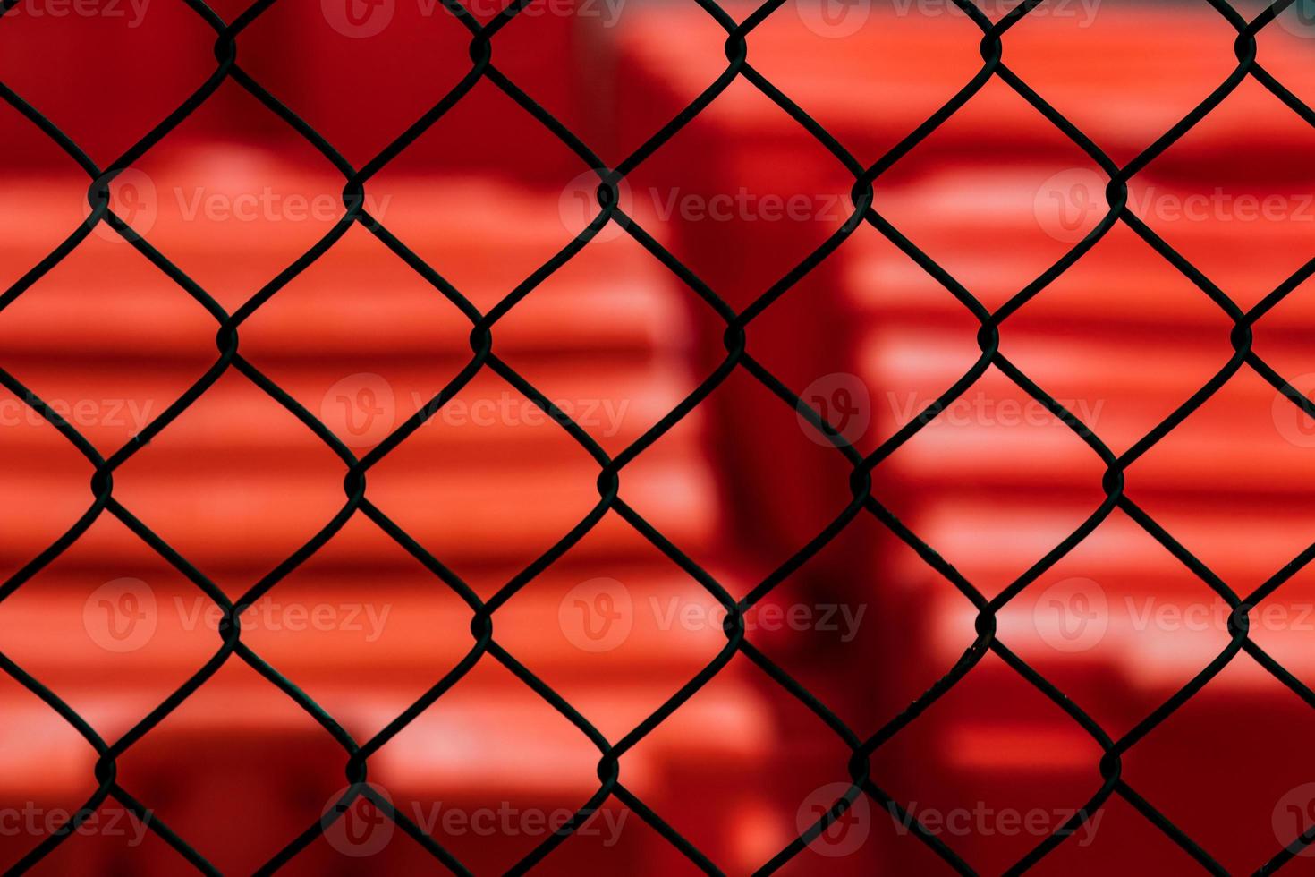 Abstract chain link fence with red photo