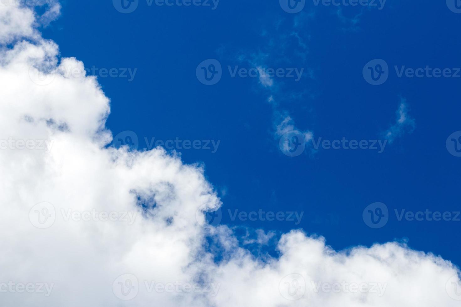 Light fluffy clouds against a blue sky photo