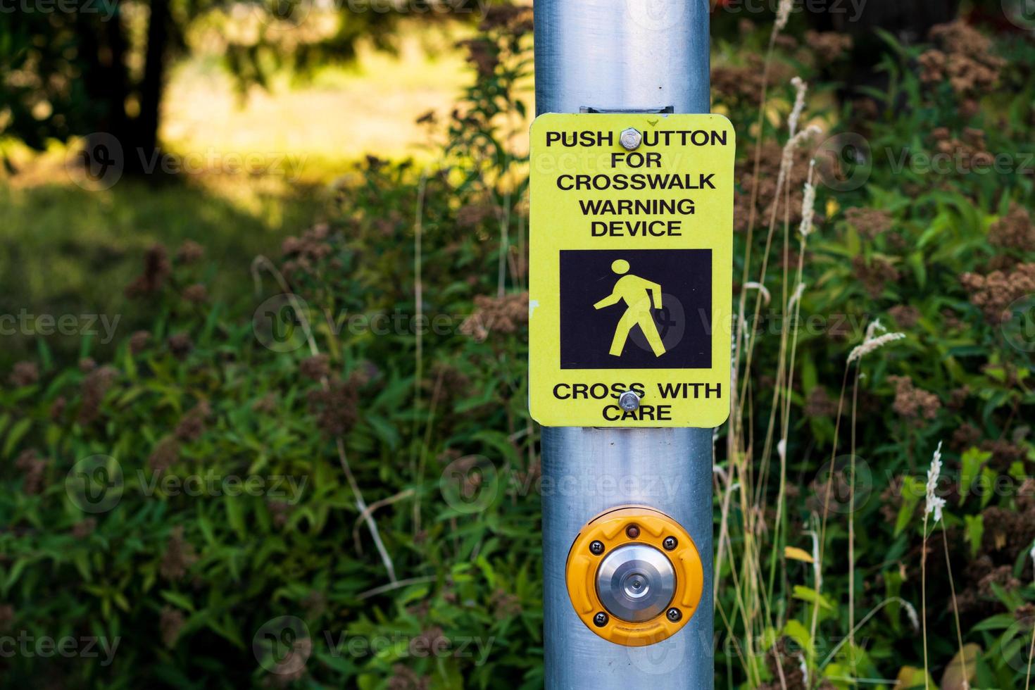 Crosswalk button mechanism on a steel post photo