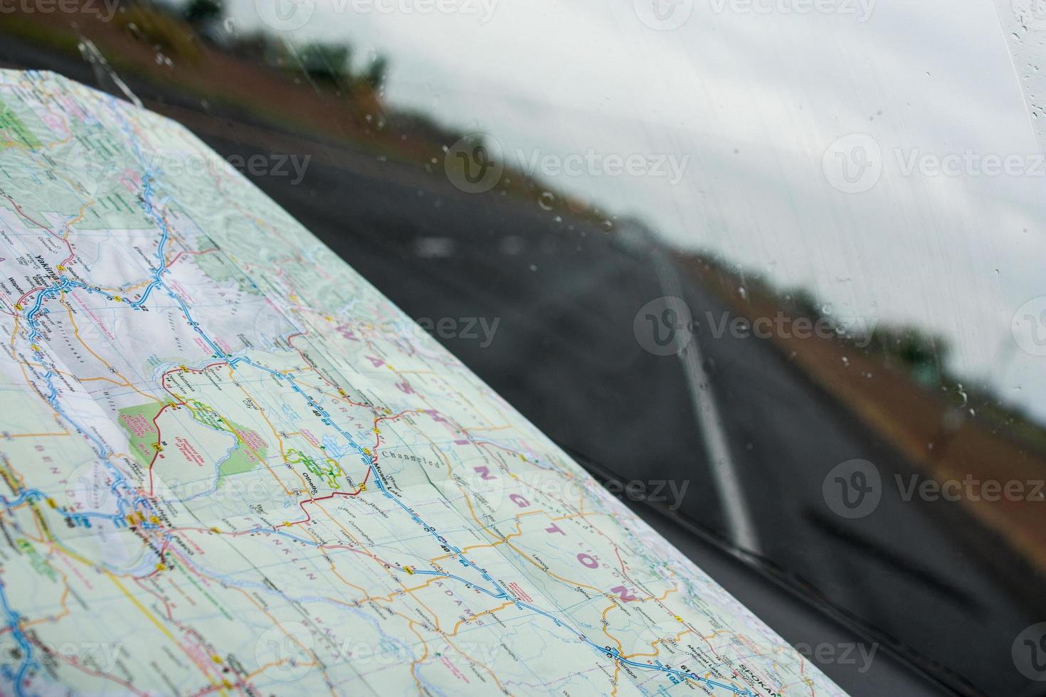 Looking through a windshield with a road map on the dashboard photo