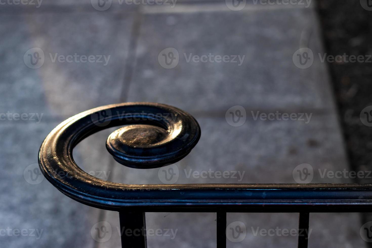 Spiral wrought iron cast black hand rail abstract photo