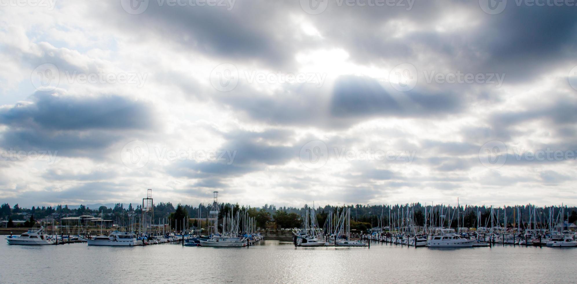 Cloudy marina with sun rays photo