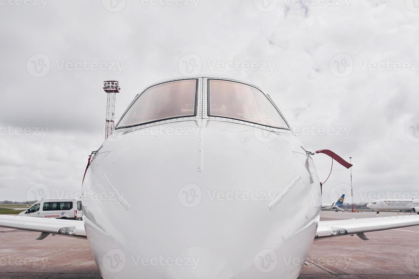 Front view. Turboprop aircraft parked on the runway at daytime photo