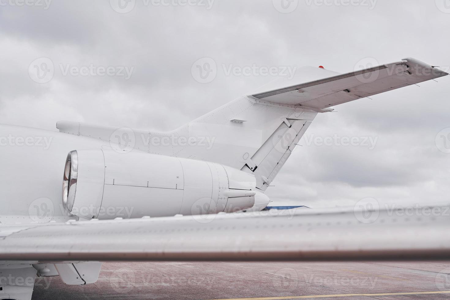 White plane. Turboprop aircraft parked on the runway at daytime photo