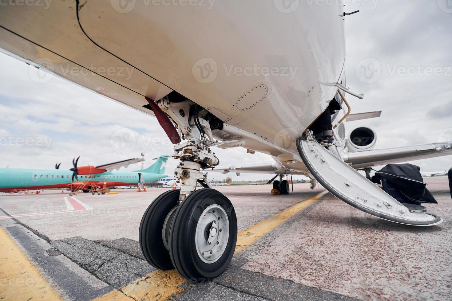 View from below. Turboprop aircraft parked on the runway at daytime photo