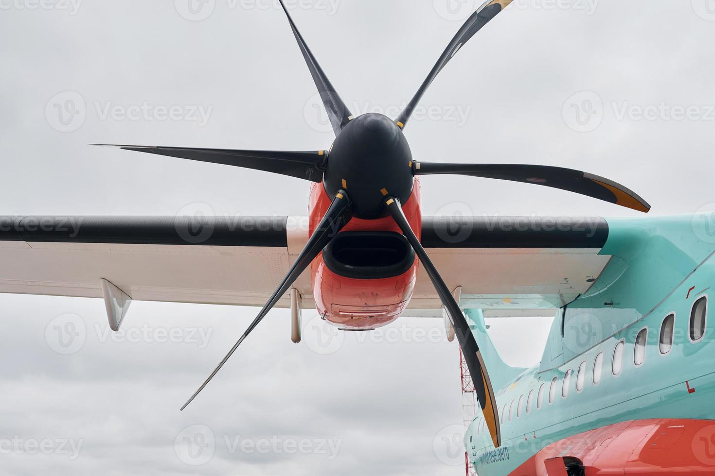 Retro style. Turboprop aircraft parked on the runway at daytime photo