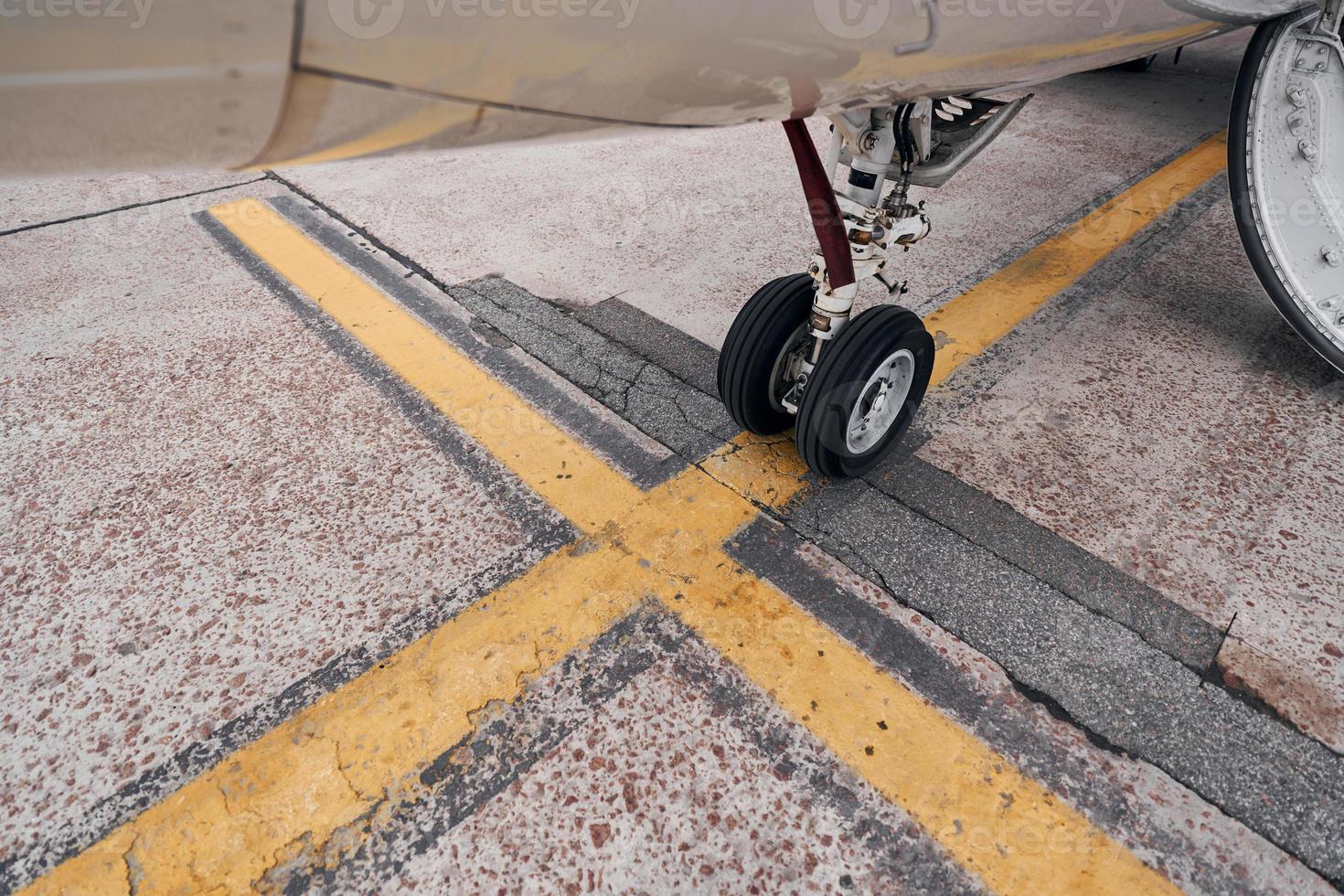 Turboprop aircraft parked on the runway at daytime photo