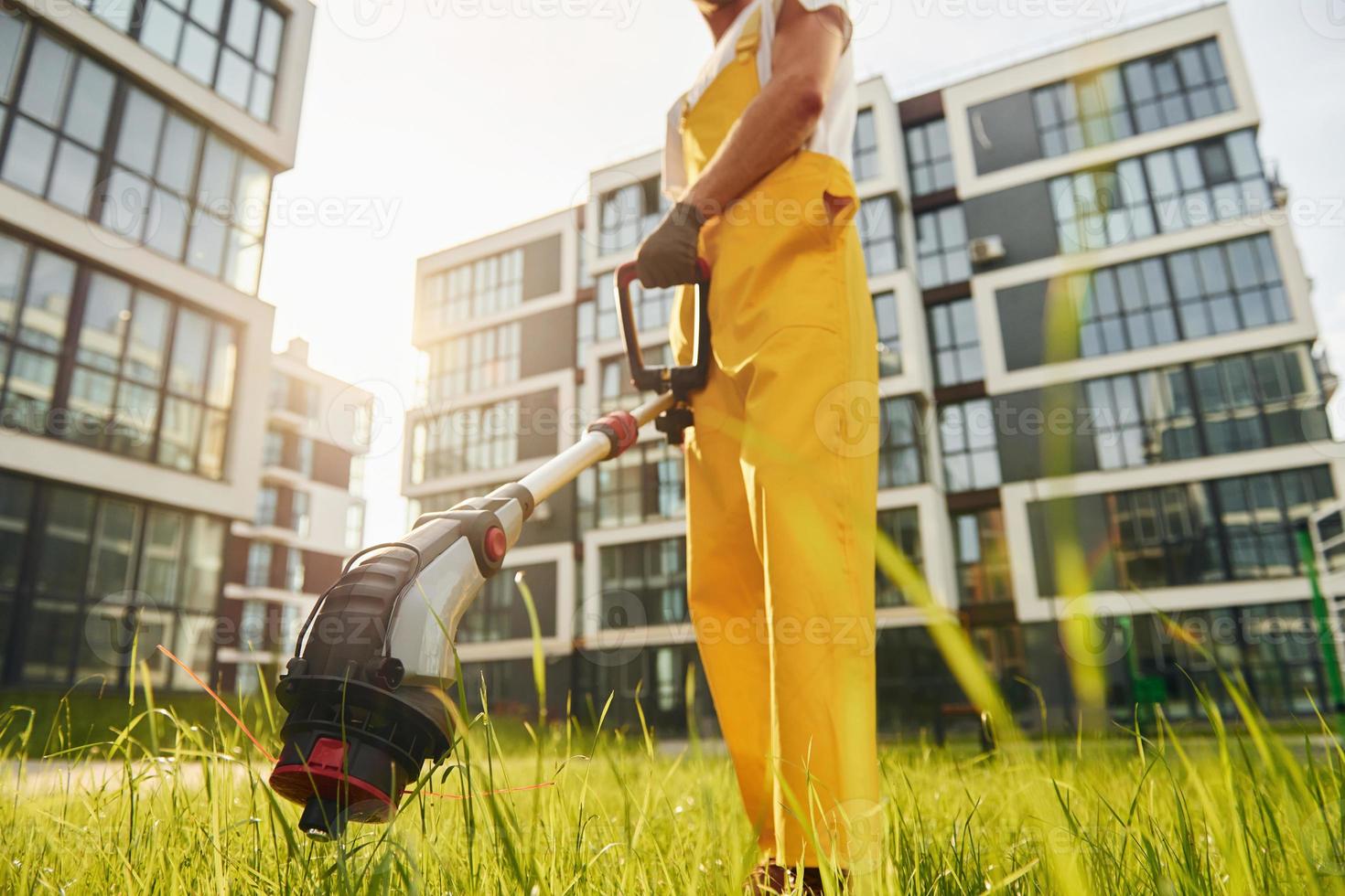 Man cut the grass with lawn mover outdoors in the yard photo