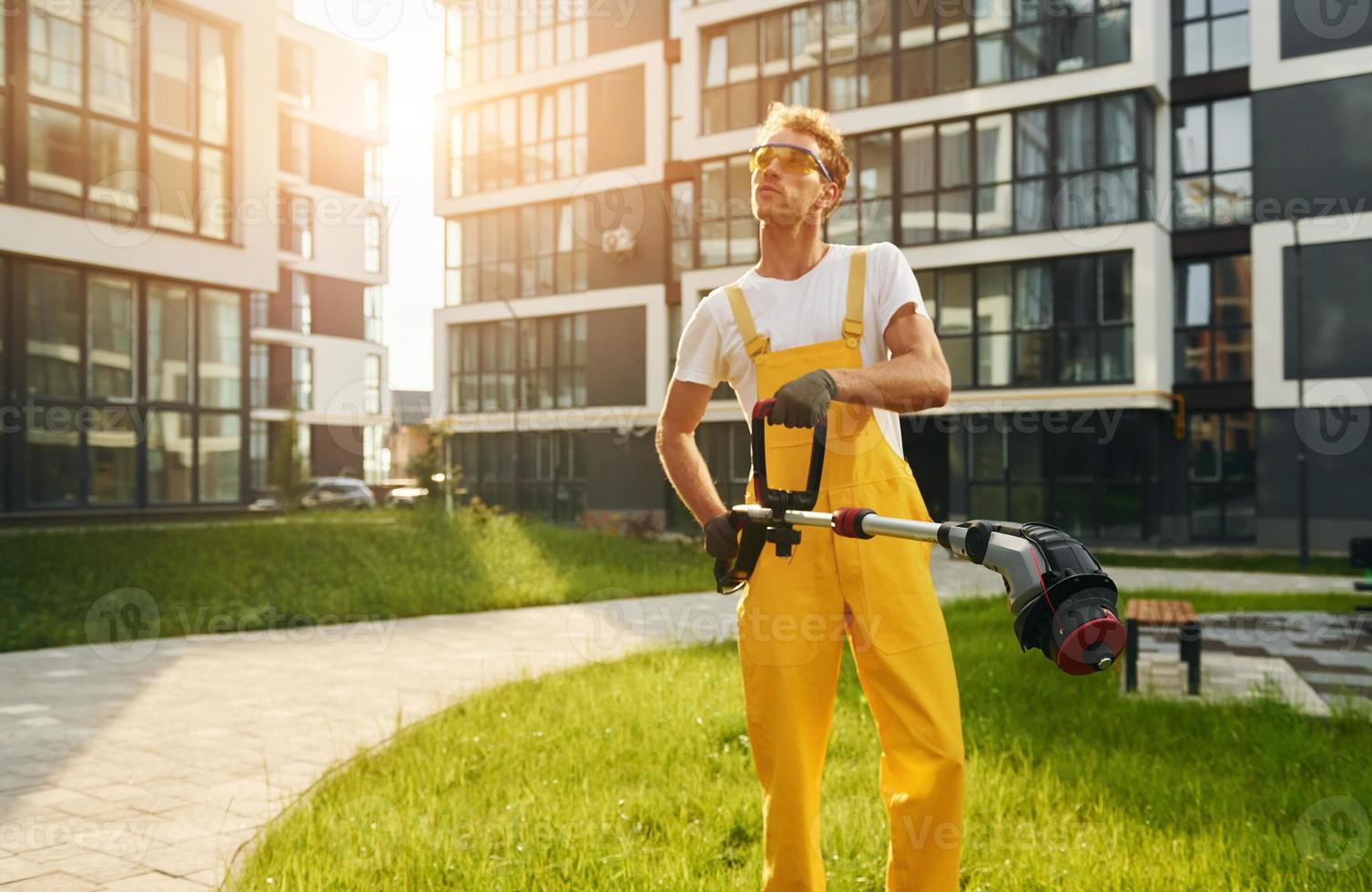 Man cut the grass with lawn mover outdoors in the yard photo