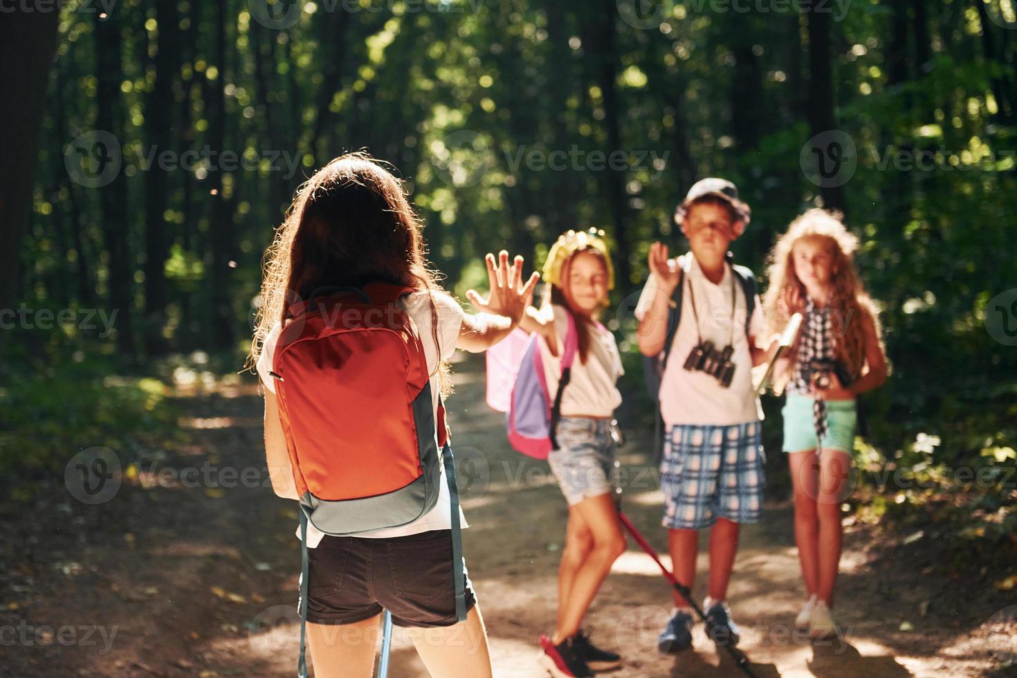 Ready for adventure. Kids strolling in the forest with travel equipment photo