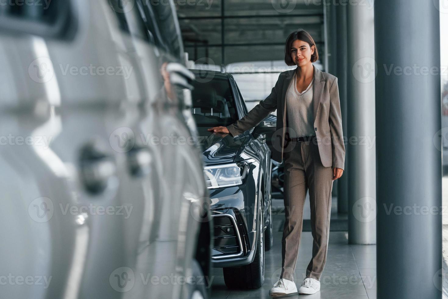Woman is indoors near brand new automobile indoors photo