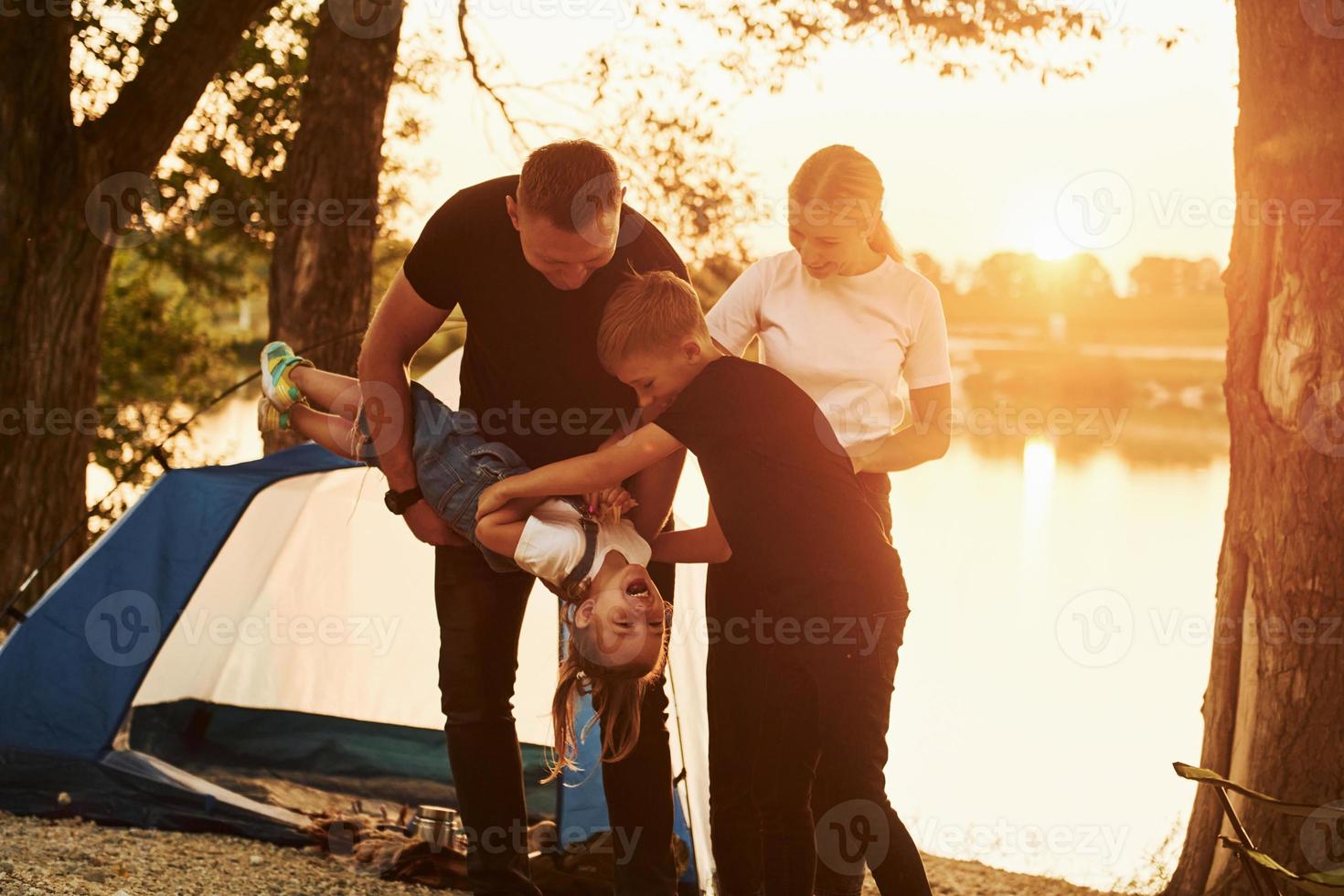 Conception of vacation. Family of mother, father and kids is on the camping photo
