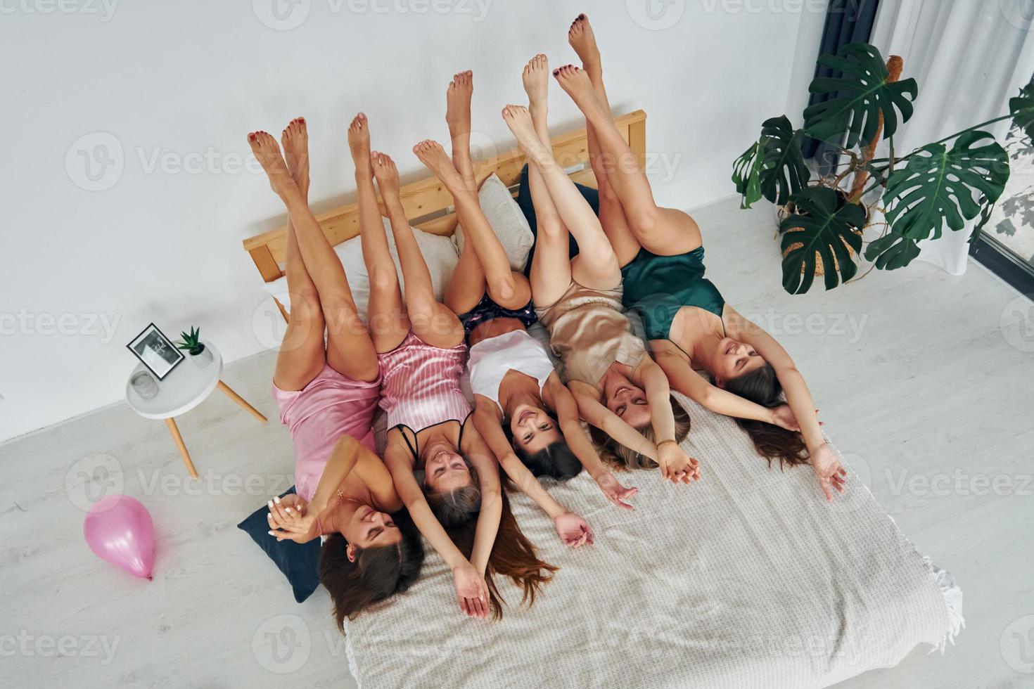 With legs up. Group of sexy happy women that is at a bachelorette party photo