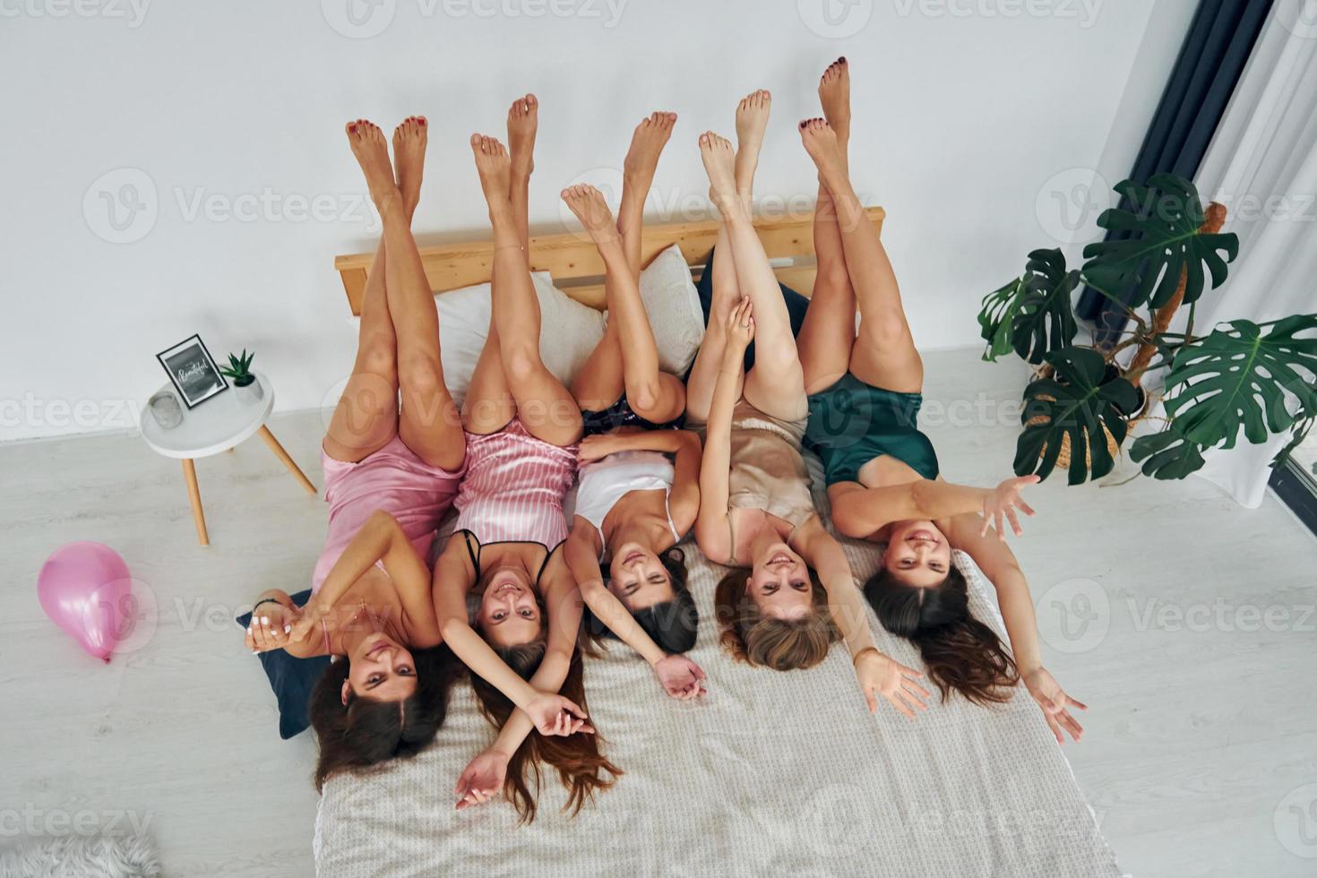 With legs up. Group of sexy happy women that is at a bachelorette party photo