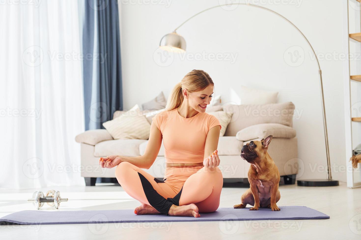 Having a rest. Woman with pug dog is at home at daytime photo