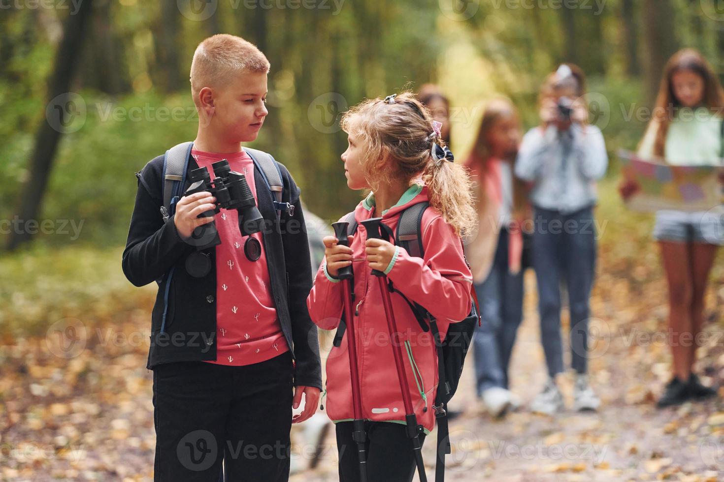 Group of people. Kids in green forest at summer daytime together photo