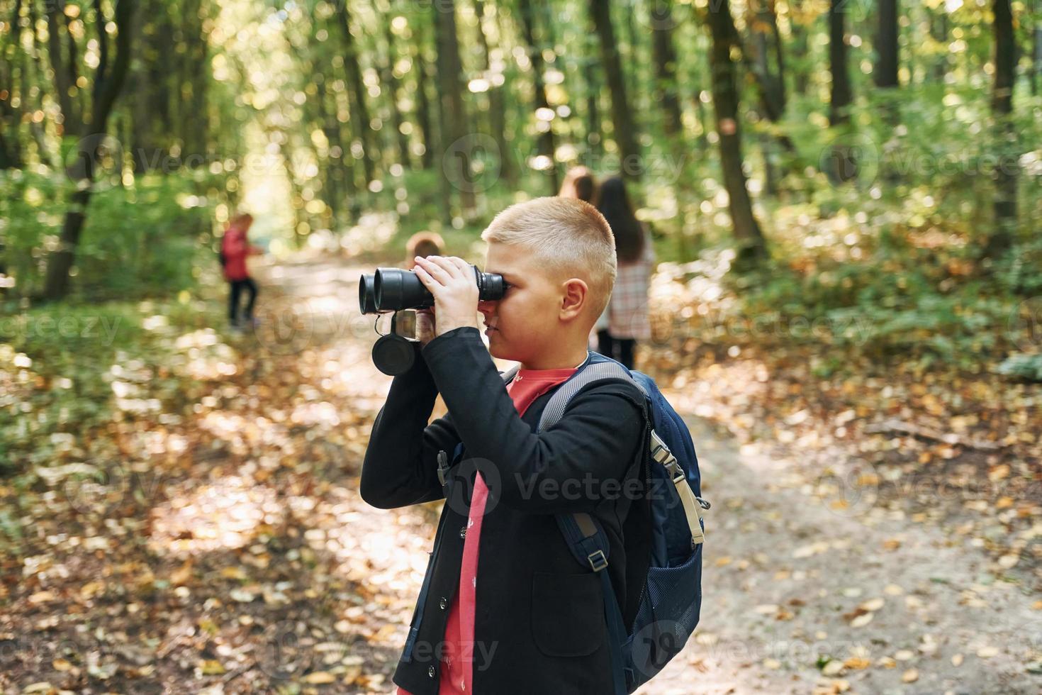 Discovering new places. Kids in green forest at summer daytime together photo