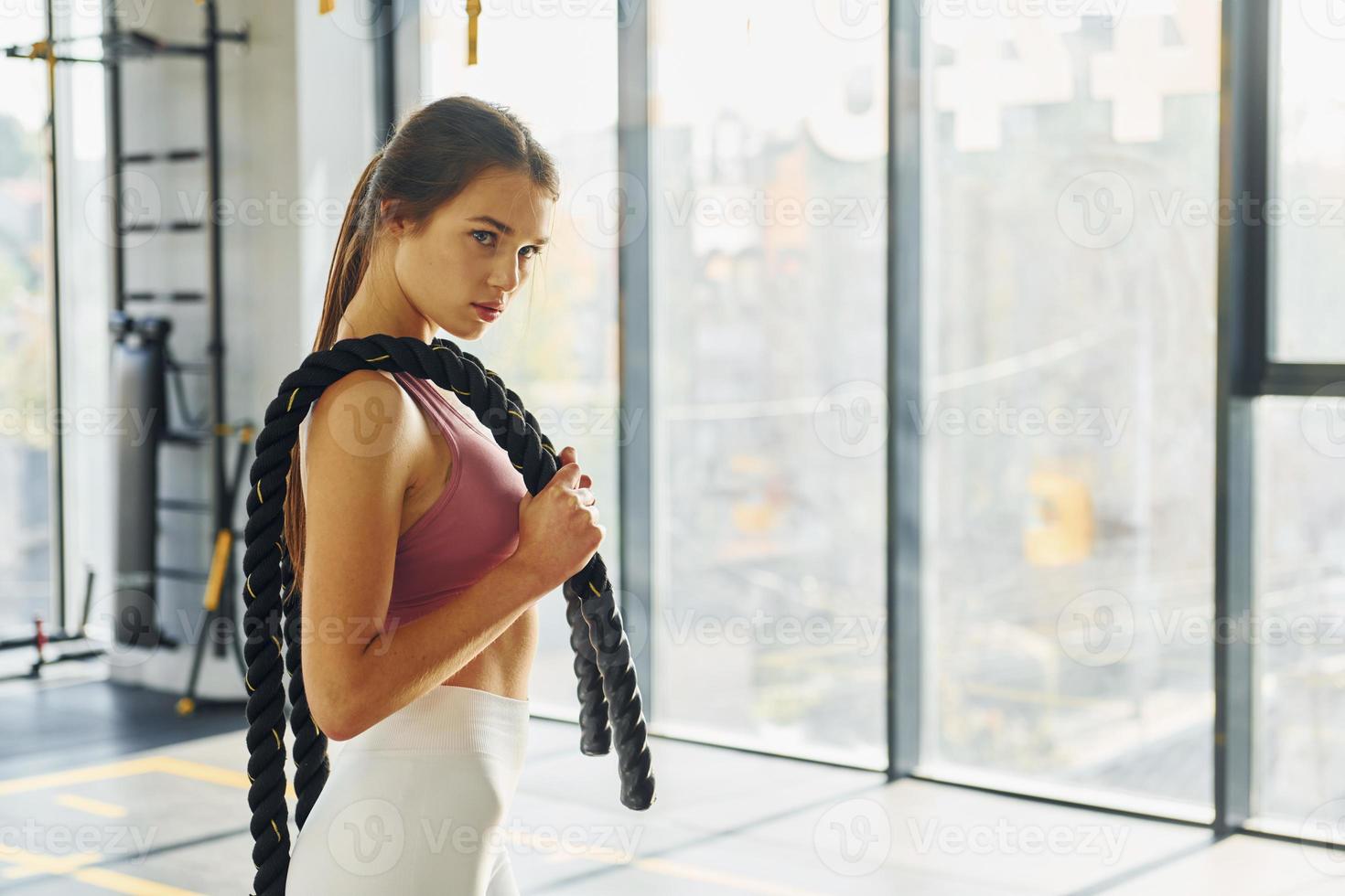 Conception of hobbies. Beautiful young woman with slim body type is in the gym photo