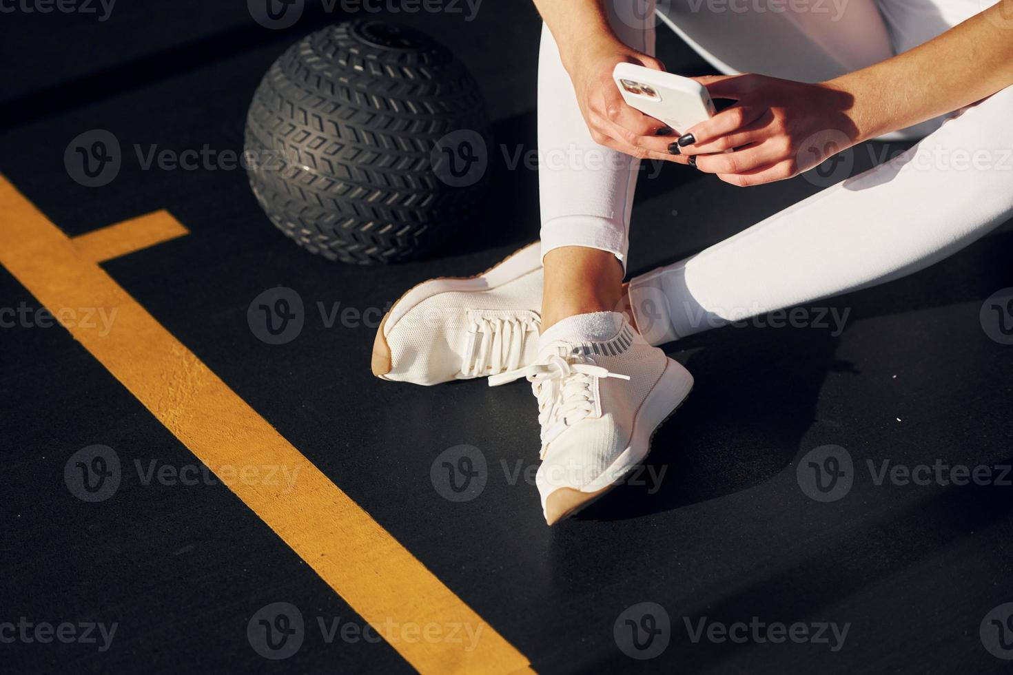 Tired beautiful young woman with slim body type is in the gym photo