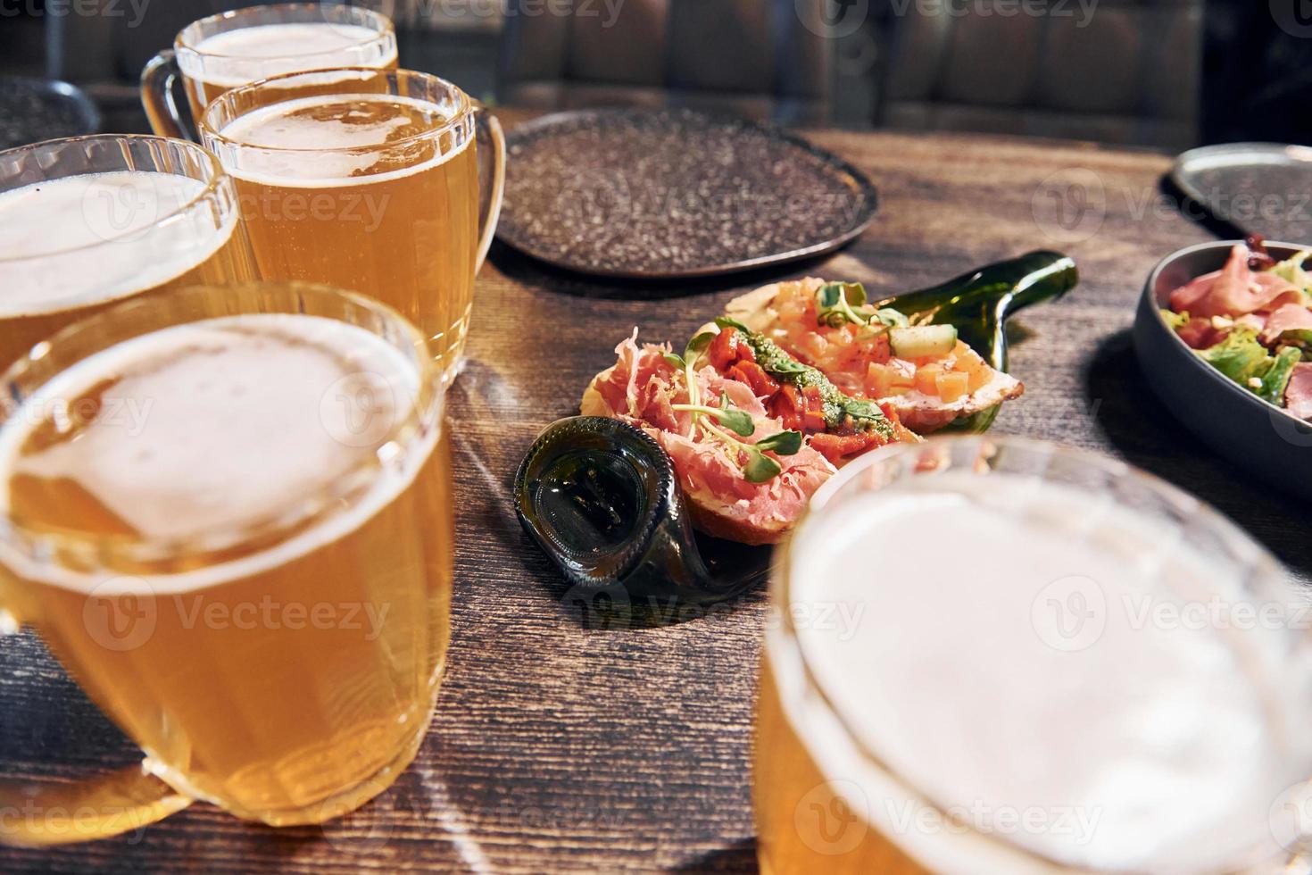 Close up view of food and beer on the table photo