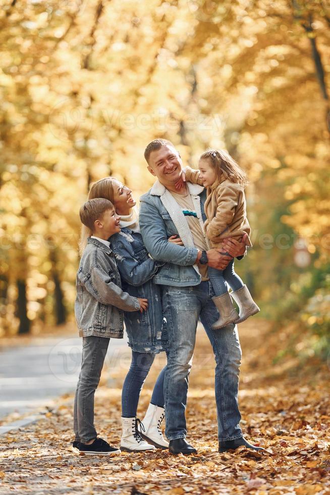 Near the road. Happy family is in the park at autumn time together photo