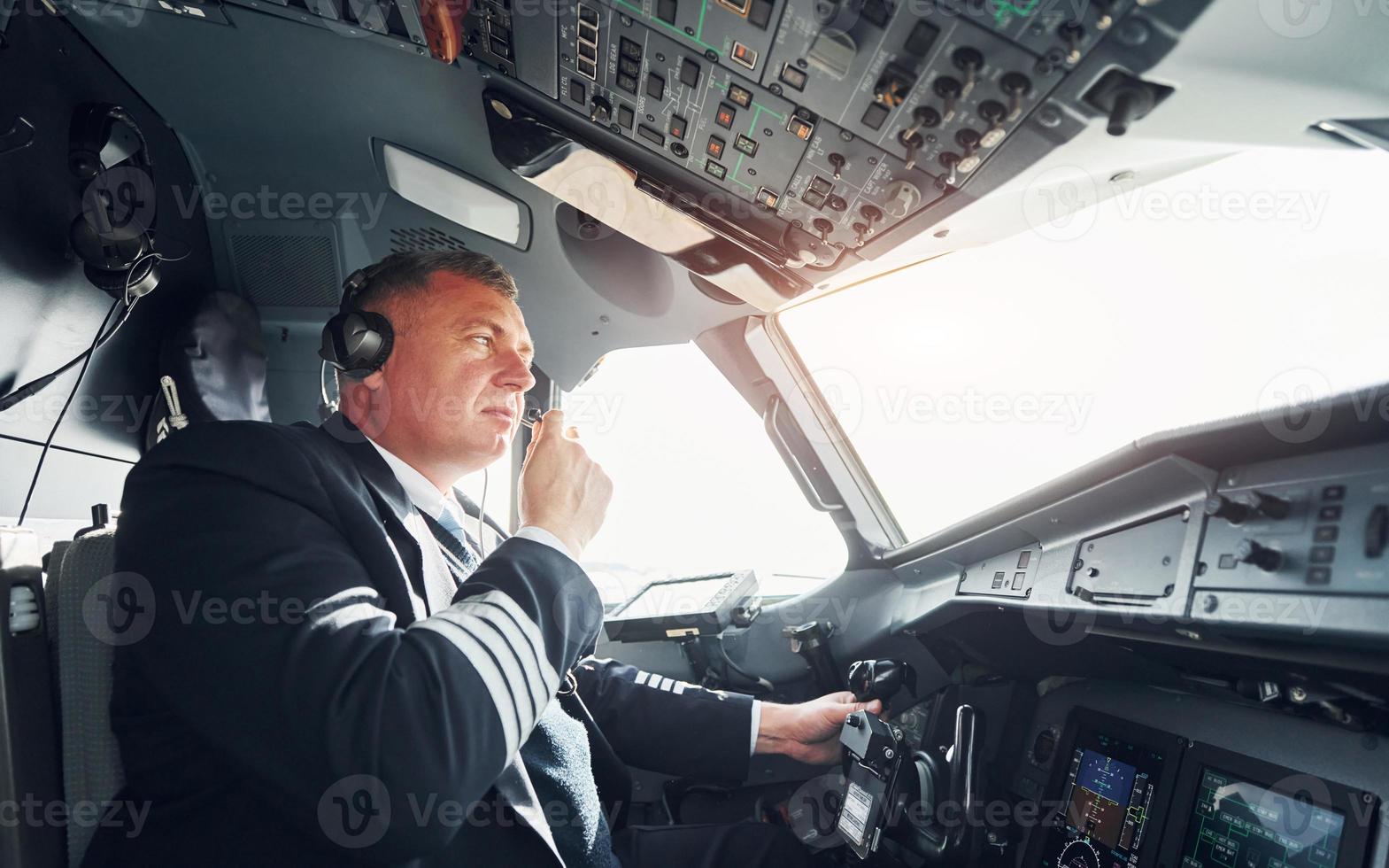 Side view. A professional pilot is in the cockpit. Conception of work photo