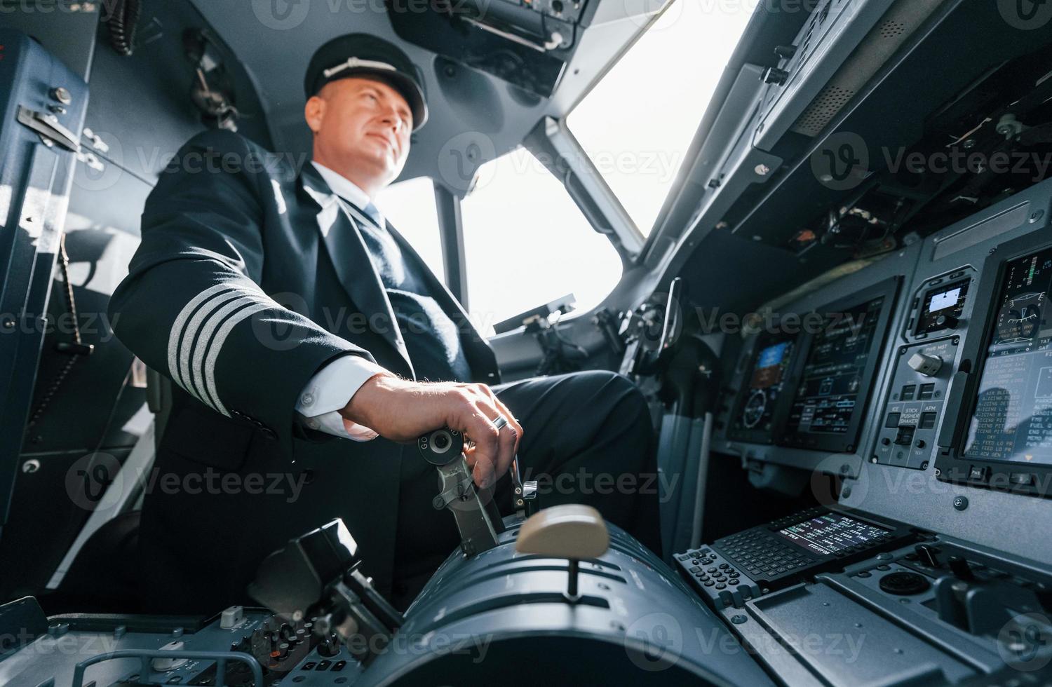 A professional pilot is in the cockpit. Conception of work photo