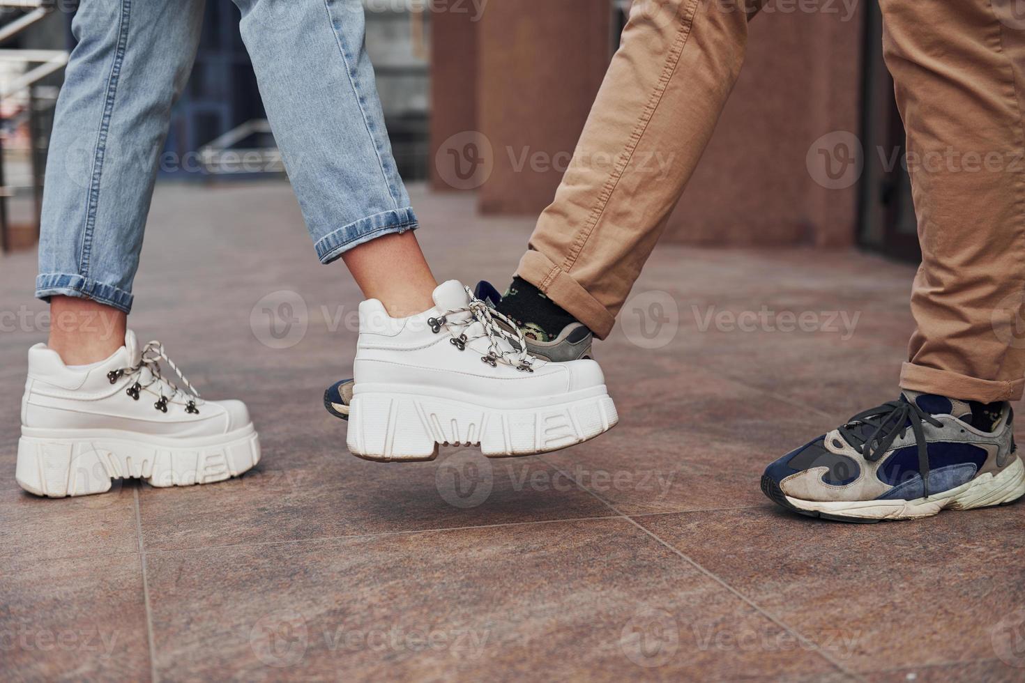 Close up view of woman's and man's legs in greeting position at quarantine time. Conception of coronavirus photo