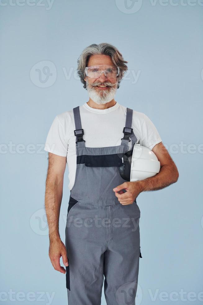 Repairman ready for work. Senior stylish modern man with grey hair and beard indoors photo