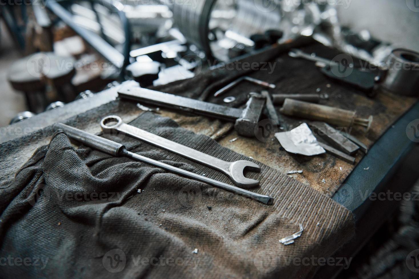 Place of work. Tools on dirty table. In garage. Manufactory conception photo