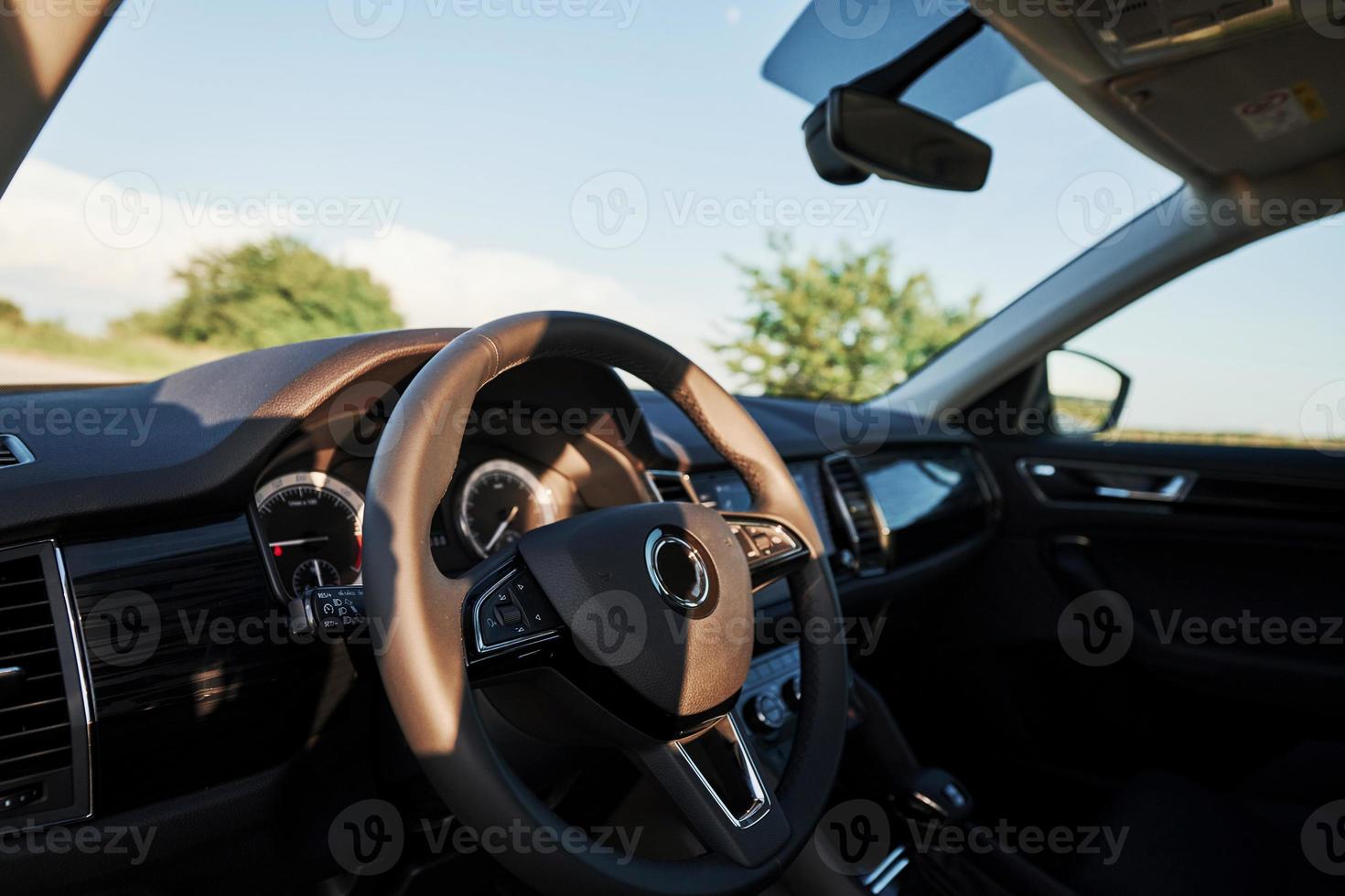 Inside modern car. Front panel, steering wheel, quality material photo