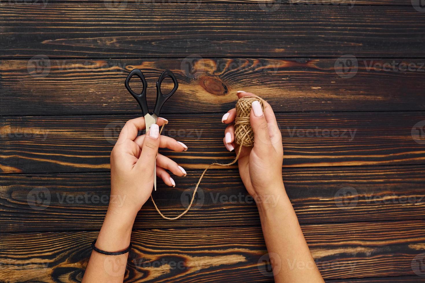 Woman's hands holds toys. Top view of christmas festive texture with new year decorations photo