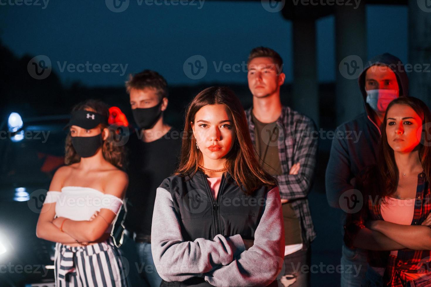 At night time. Group of protesting young people that standing together. Activist for human rights or against government photo