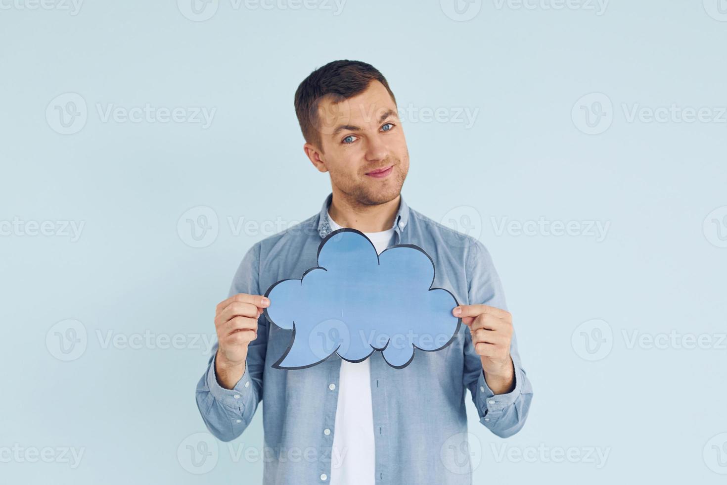 Holding sign. Man standing in the studio photo