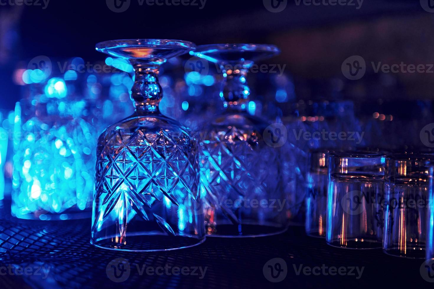 Close up view of row of empty glasses on table in the pub indoors photo