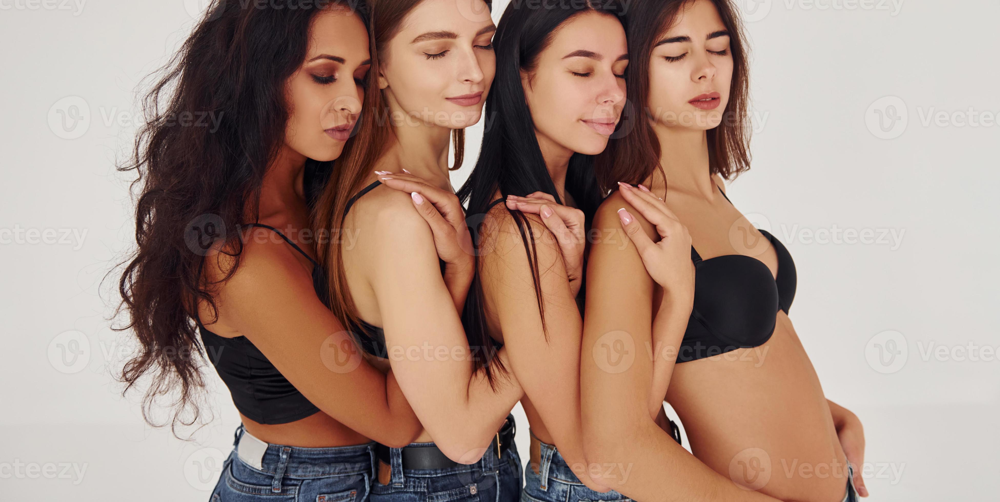 Leaning on each other. Four young women in lingerie together indoors. White  background 15463714 Stock Photo at Vecteezy