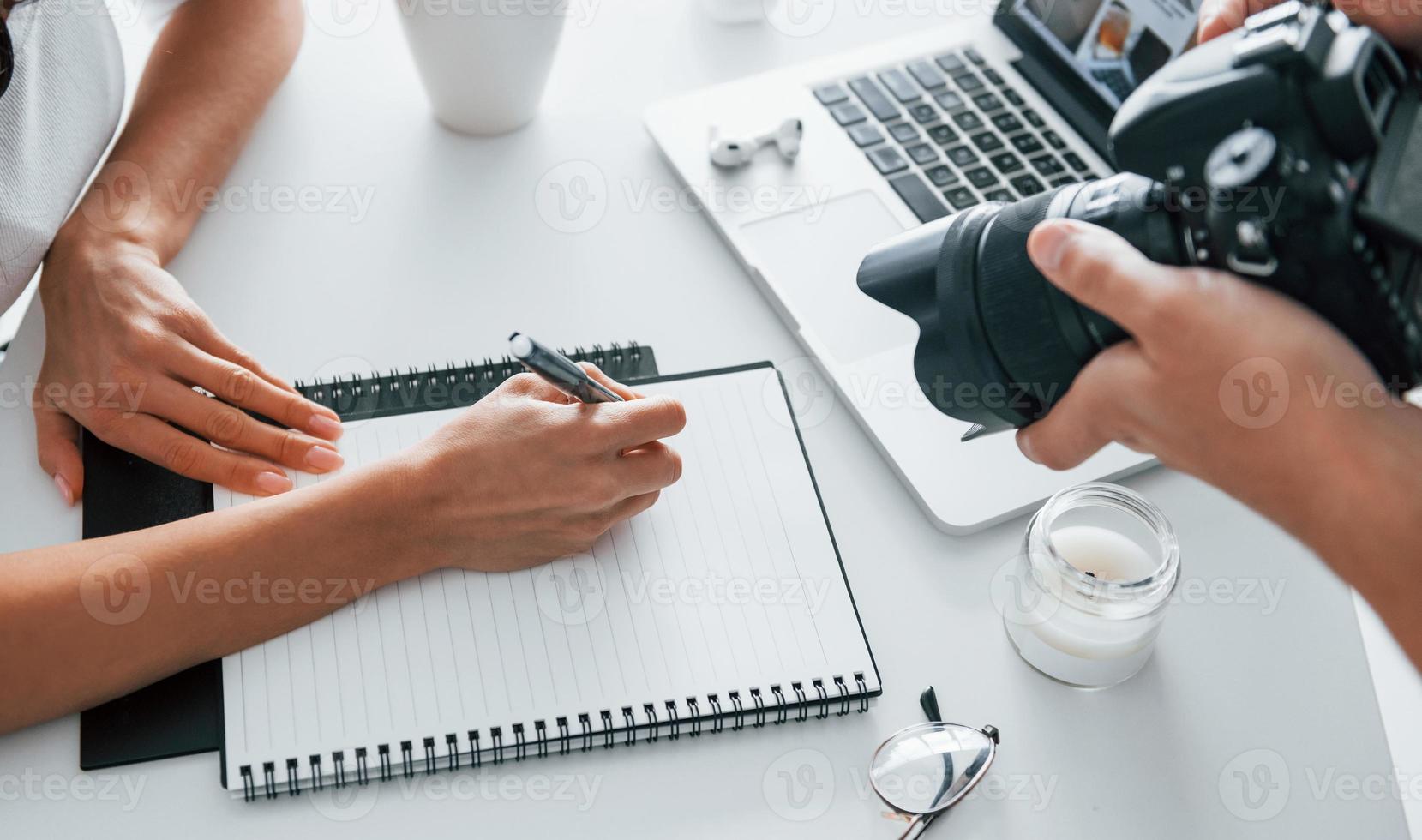 Photographer at work. Two young female freelancers indoors in the office at daytime photo