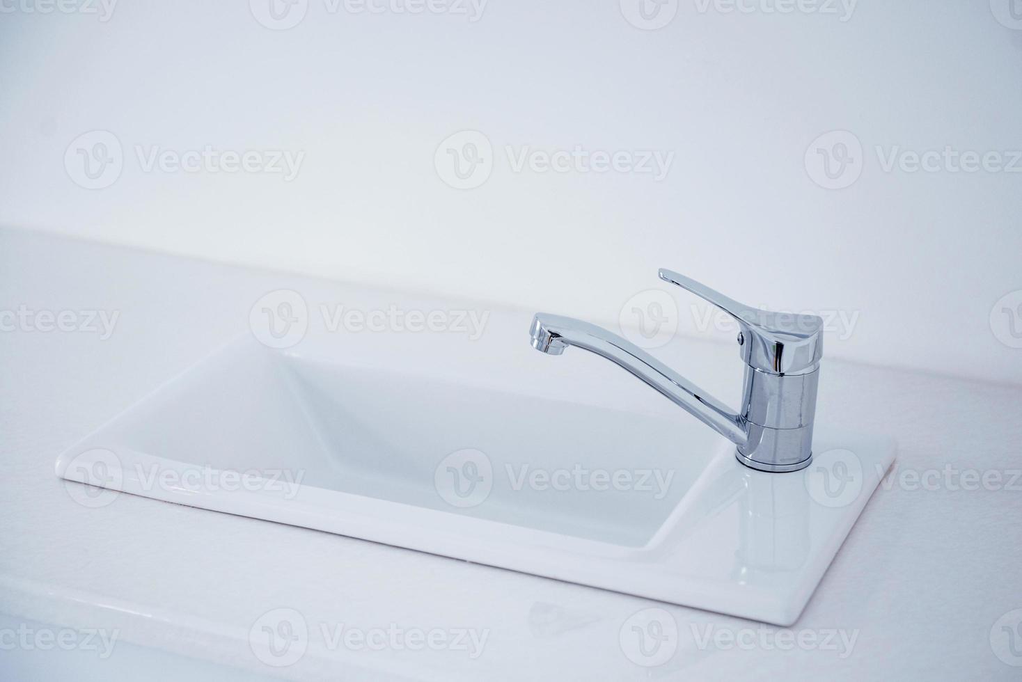 Close up view of domestic metal faucet. Clean surface photo