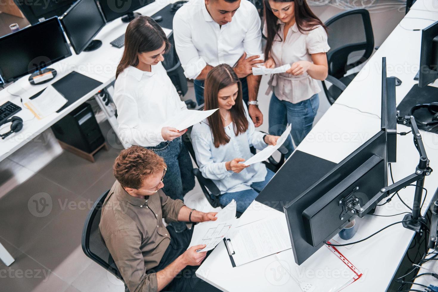 Group of young business people that working by computers in the modern office photo