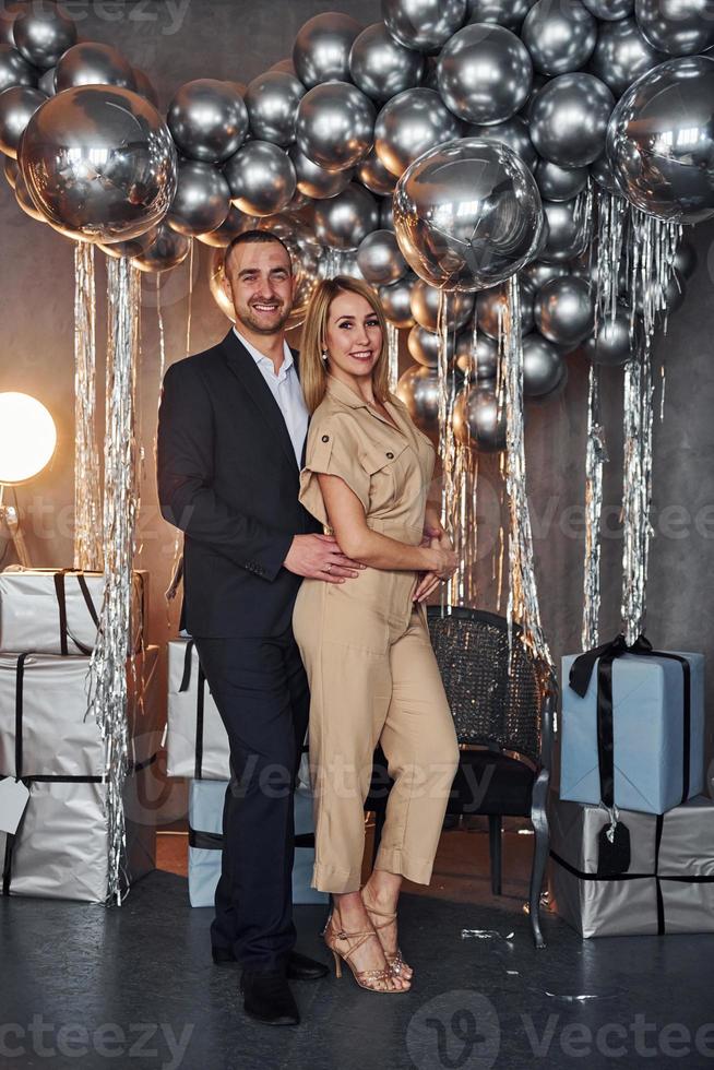 Couple is in christmas decorated room together. Celebrating New Year photo