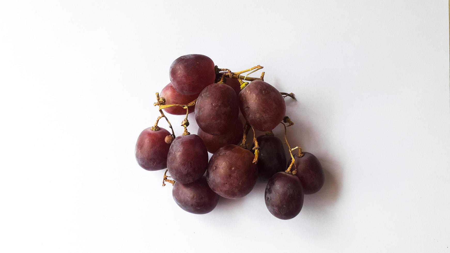 Red fresh grapes red grapes display on white background photo