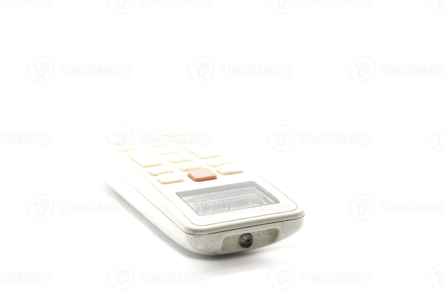 dusty air conditioner remote on a white background using a flash for clarity in my home studio. photo