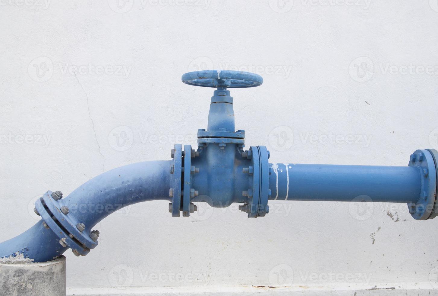 Large water supply valve with a white background of the cement wall photo