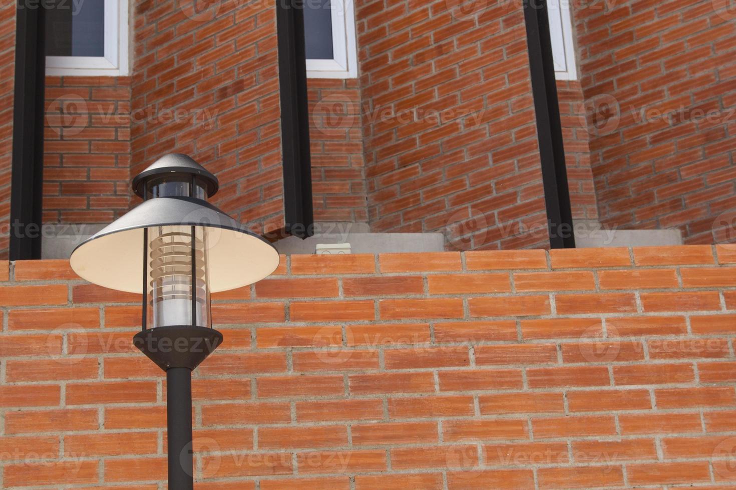 Electric lamp on a red brick wall, modern style that is decorated to be old and retro. photo