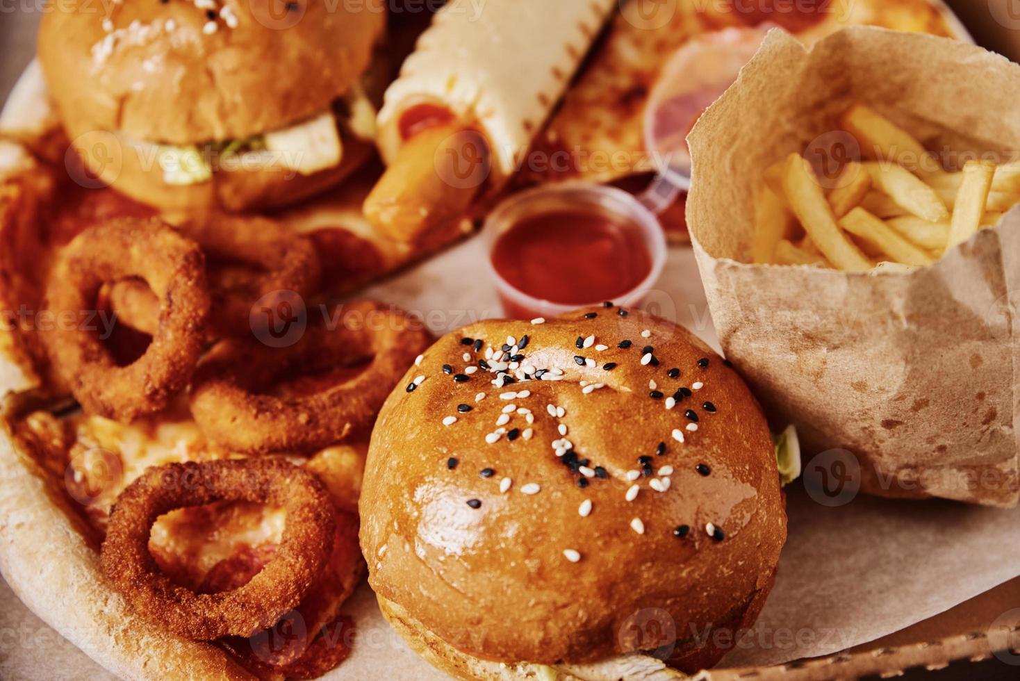 Unhealthy and junk food. Different types of fast food on the table, closeup photo