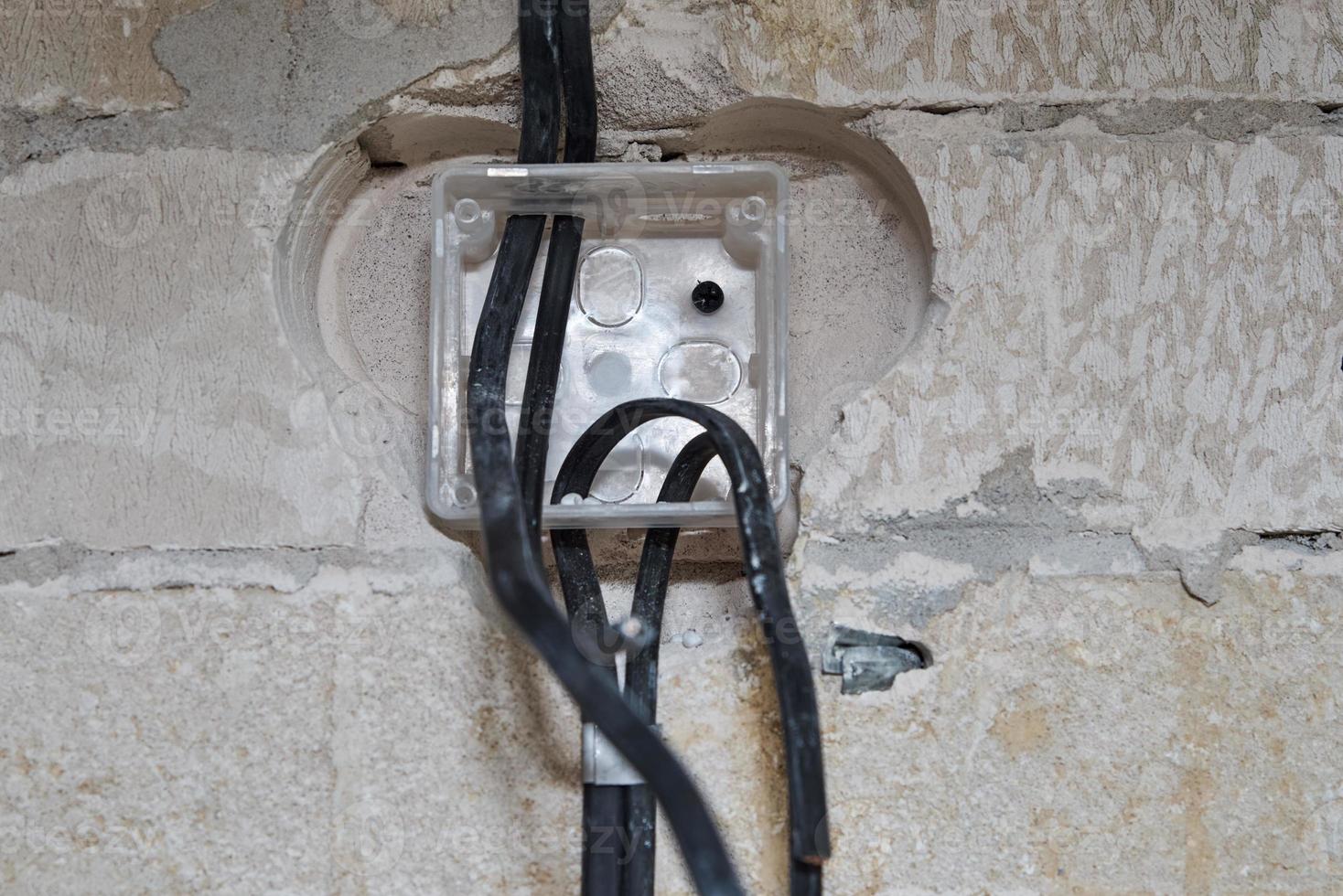 Socket for wiring in a concrete wall. Renovation concept photo