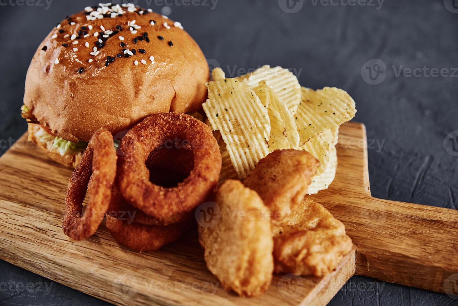 Unhealthy and junk food. Different types of fast food on the table, closeup photo