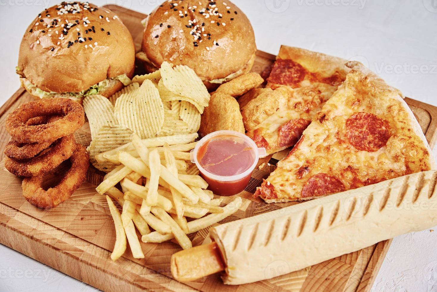 Unhealthy and junk food. Different types of fast food on the table, closeup photo